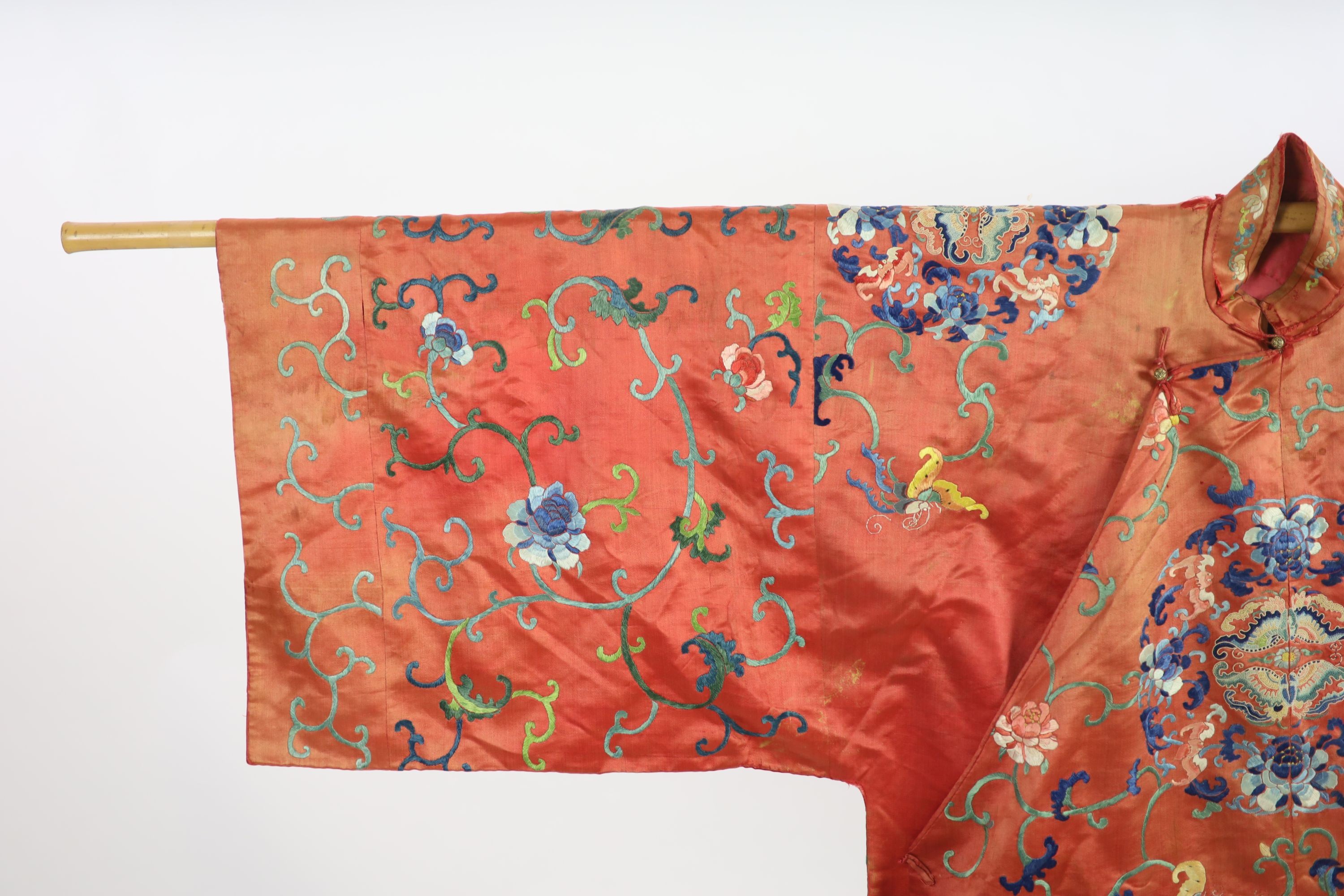 A Chinese apricot silk robe, mid 19th century, 125 cm long, wear to back of collar